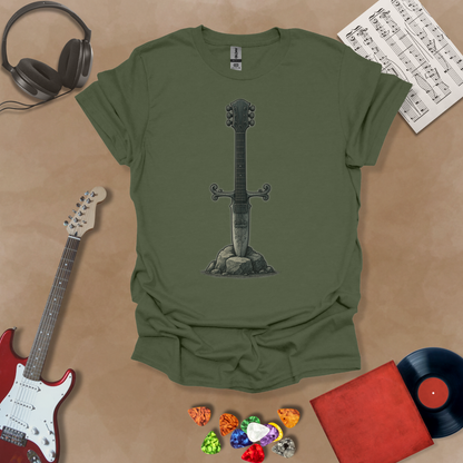 Green t-shirt with Illustration of a battle-worn guitar sword glowing with a smoky gray aura, titled Axecalibur: Forged in Shadow, printed on a dark tee by Riff Junkie.