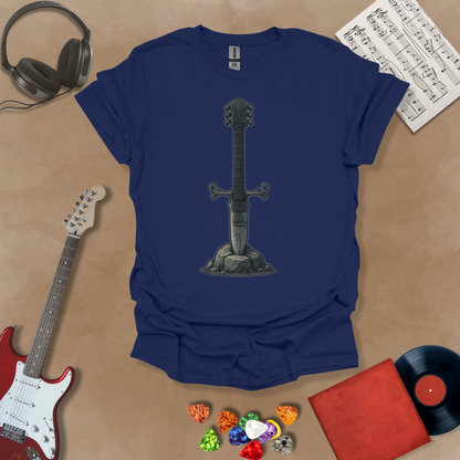 Navy t-shirt with Illustration of a battle-worn guitar sword glowing with a smoky gray aura, titled Axecalibur: Forged in Shadow, printed on a dark tee by Riff Junkie.