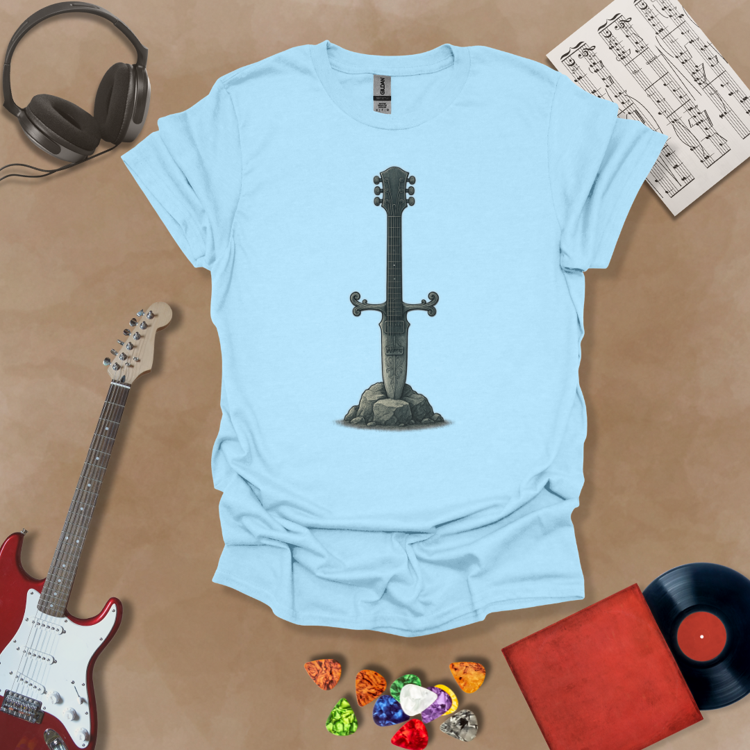 Light blue T-shirt with detailed illustration of a stone-forged guitar sword glowing in silver tones, titled Axecalibur: Blade of Light, printed on a light tee by Riff Junkie.