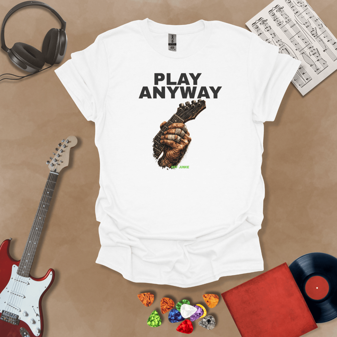 Play Anyway – Riff Edition graphic White t-shirt featuring bold stacked text above a weathered hand gripping a guitar fretboard with taped fingers and Riff Junkie branding.