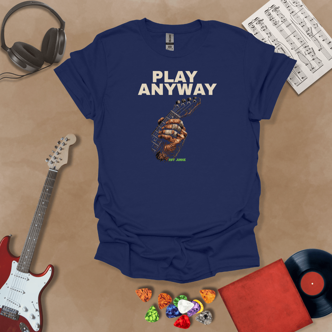 Play Anyway – Riff Edition graphic Navy t-shirt featuring bold stacked text above a weathered hand gripping a guitar fretboard with taped fingers and Riff Junkie branding.