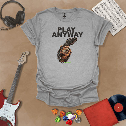 Play Anyway – Riff Edition graphic Gray t-shirt featuring bold stacked text above a weathered hand gripping a guitar fretboard with taped fingers and Riff Junkie branding.