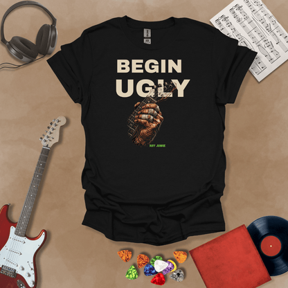 Begin Ugly – Riff Edition black graphic t-shirt featuring bold stacked text above a weathered hand gripping a guitar fretboard with taped fingers and subtle Riff Junkie branding.
