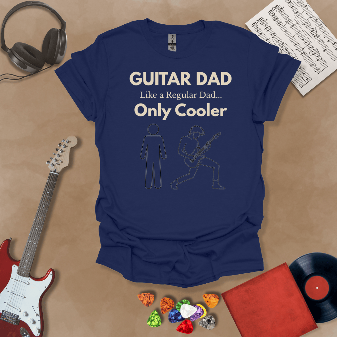A Navy Guitar Dad Sketch Edition t-shirt featuring a hand-drawn illustration of a regular dad and a rocker dad, laid flat on a tan background with guitar-themed props.