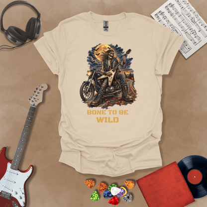 A sand t-shirt featuring Bone to Be Wild Halloween graphic featuring a skeleton rocker playing an electric guitar on a motorcycle beneath a full moon with bats and autumn leaves, optimized for dark and light shirt colors.