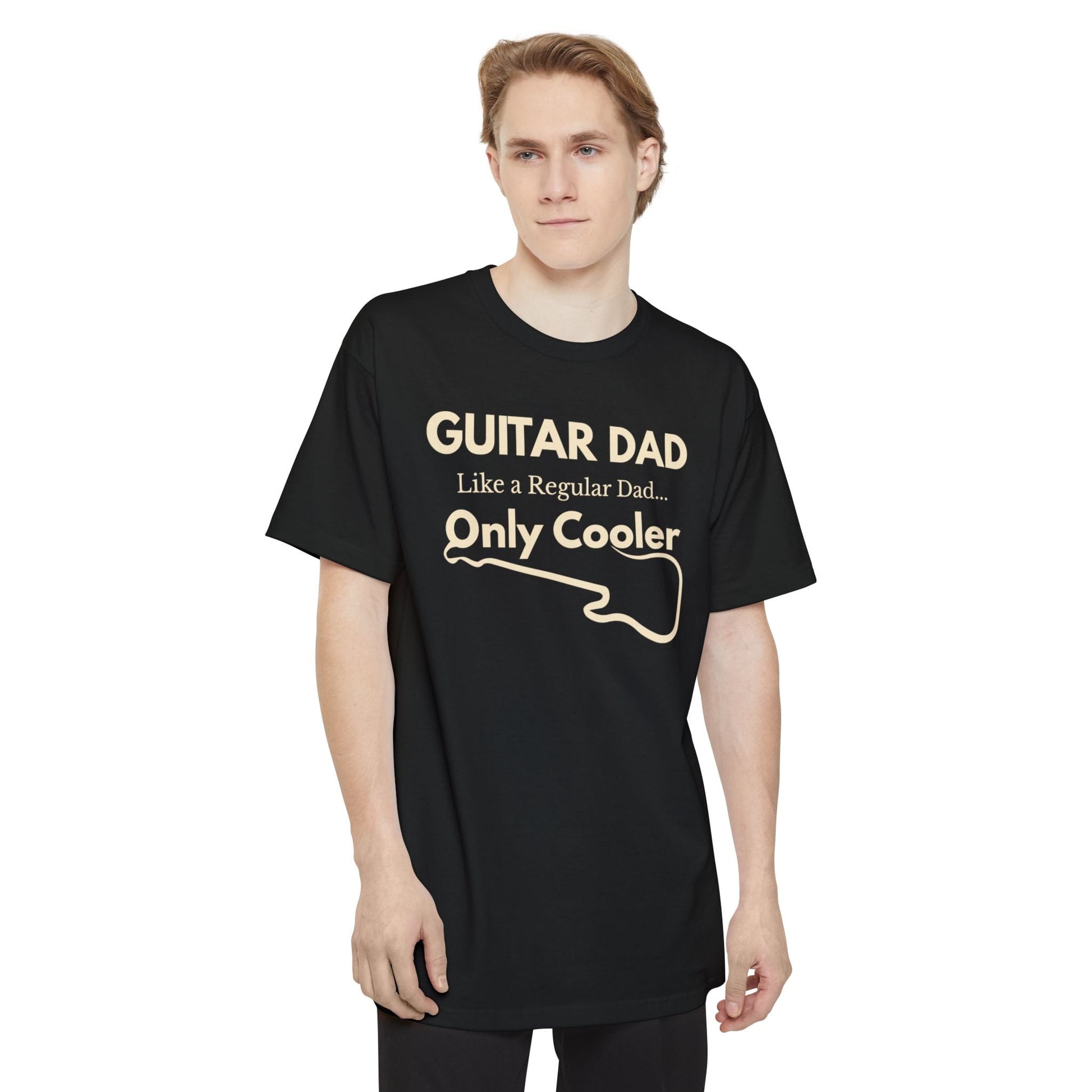 A male wearing a black Guitar Dad Signature Edition Tall Fit t-shirt  featuring a light beige guitar-inspired graphic on the front with integrated typography, designed with extra length for a comfortable fit.