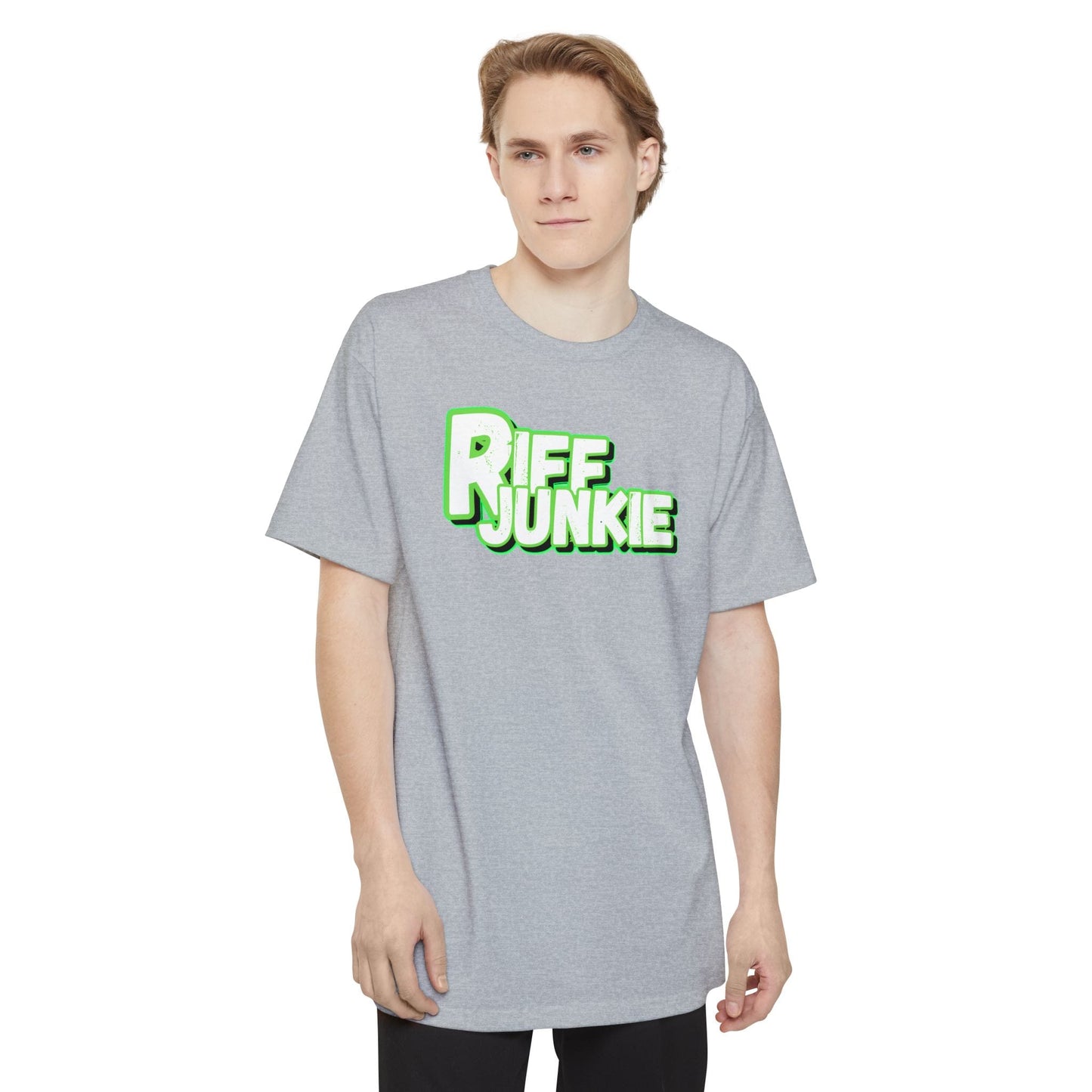 A man wearing a light gray t-shirt featuring a bold graphic on the chest that reads 'RIFF JUNKIE' in a stylized green and white font, displayed against a solid white background.
