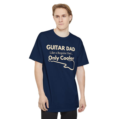 A male wearing a navy Guitar Dad Signature Edition Tall Fit t-shirt featuring a light beige guitar-inspired graphic on the front with integrated typography, designed with extra length for a comfortable fit.